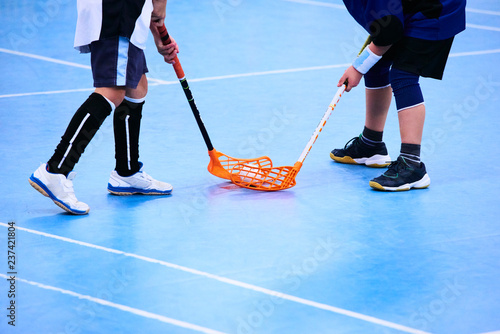 Floorball child boy player with stick and ball. Children playing florball sport