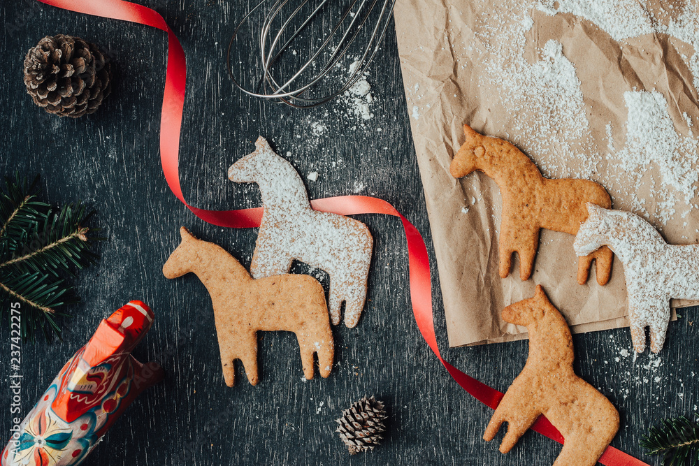 Rustic and messy composition of dala horse cookies - obrazy, fototapety, plakaty 