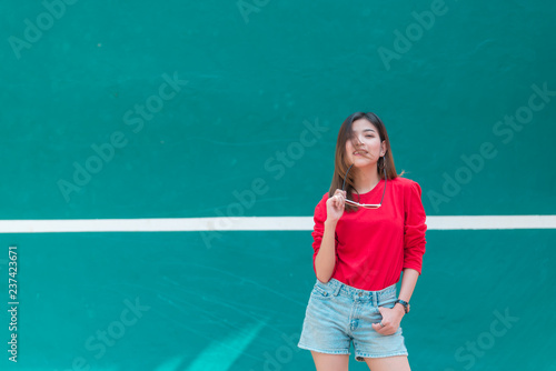 Portrait of beautiful asian woman wear skirt at tennis course,Pose for take a picture,Thailand people,Lifestyle of modern girl