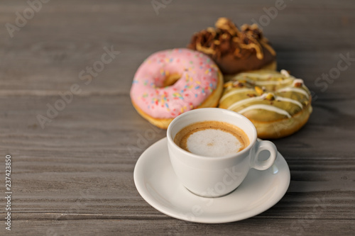 Cup of coffee and doughnuts  shallow depth of field.