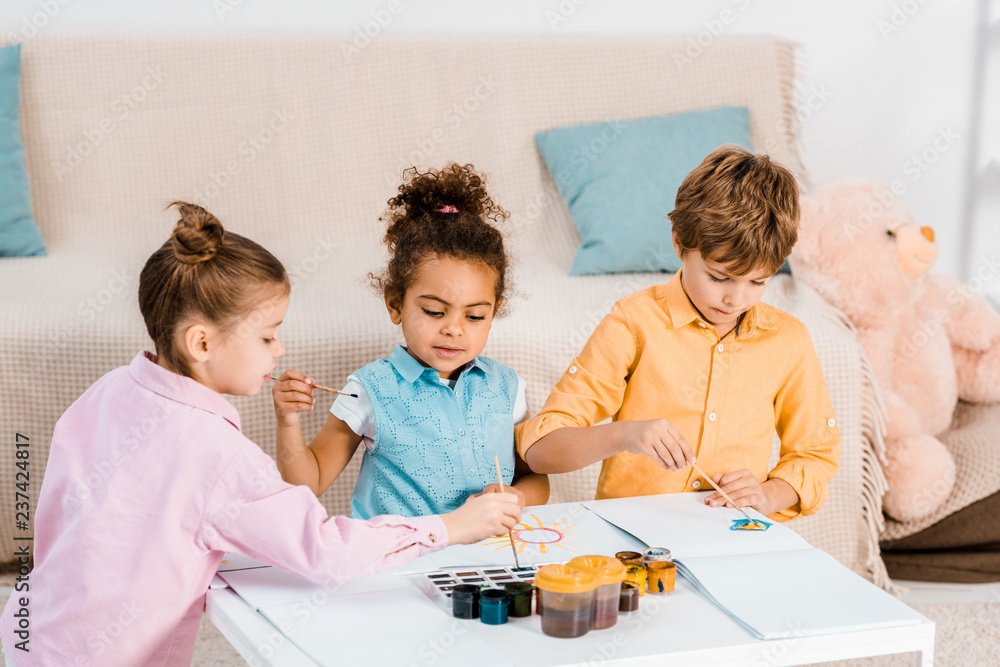 adorable little multiethnic children painting together adorable little multiethnic children painting together