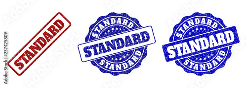 STANDARD grunge stamp seals in red and blue colors. Vector STANDARD marks with grunge surface. Graphic elements are rounded rectangles, rosettes, circles and text captions.