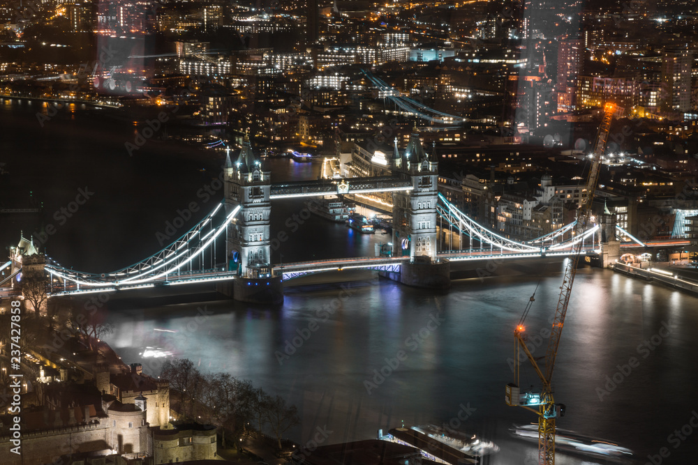 London, England - Tower Bridge and River Thames aerial view with reflections.