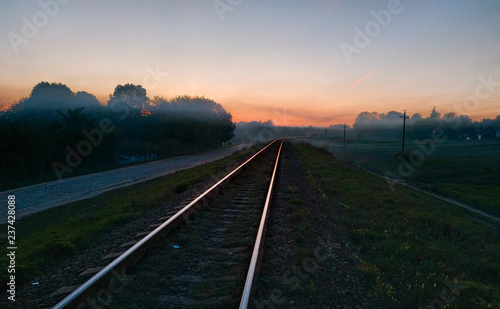 Sunset Over Railway Tracks sunset twilight nature hazefog grass field