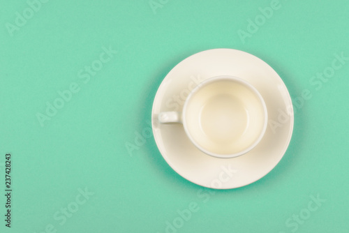 Empty cup on green background