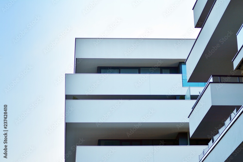 Modern apartment buildings on a sunny day with a blue sky. Facade of a modern apartment building Modern apartment buildings on a sunny day with a blue sky. Facade of a modern apartment building