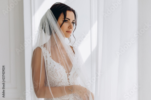 Morning of the bride. Portrait of a bride in a white dress. photo