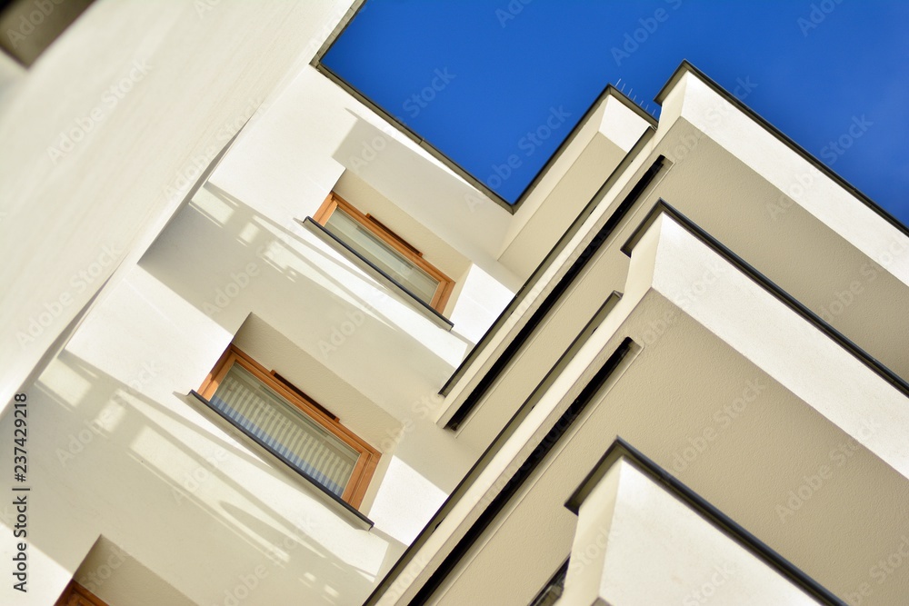 Modern apartment buildings on a sunny day with a blue sky. Facade of a modern apartment building Modern apartment buildings on a sunny day with a blue sky. Facade of a modern apartment building