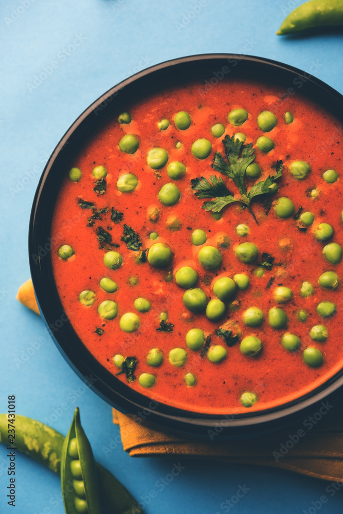 Green Peas curry / Matar masala served in a bowl over moody background. selective focus Green Peas curry / Matar masala served in a bowl over moody background. selective focus