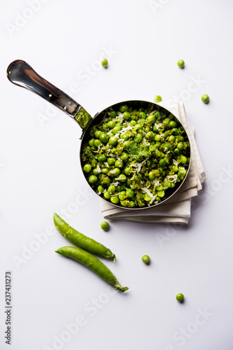 Green peas dry recipe or matar ki sookhi sabji, served in a serving pan or terracotta bowl. Selective focus