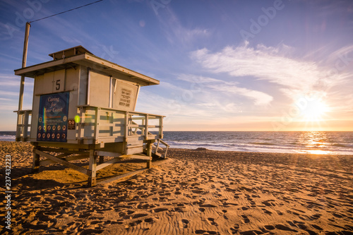 Lifeguard tower on one of the sandy Malibu beaches; beautiful sunset light; Pacific Ocean coastline, California