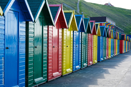 Vászonkép f brightly painted beach huts at Whitby on the Yorkshire coast