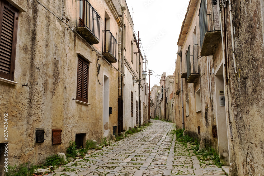 Typical narrow stone street in the medieval historical center of Erice, Sicily