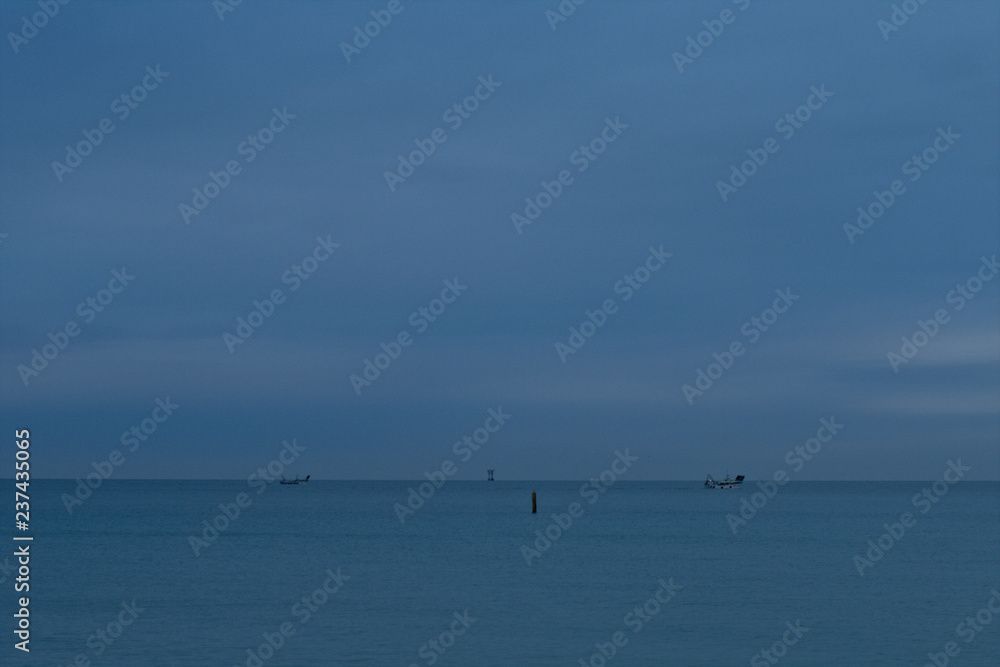 fishing boat in the sea,water, sky,boat,horizon, calm,cloud, ship,