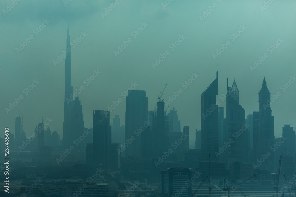 Dubai, UAE - October, 2018. Beautiful skyline of Dubai surrounded by sand dust at day light