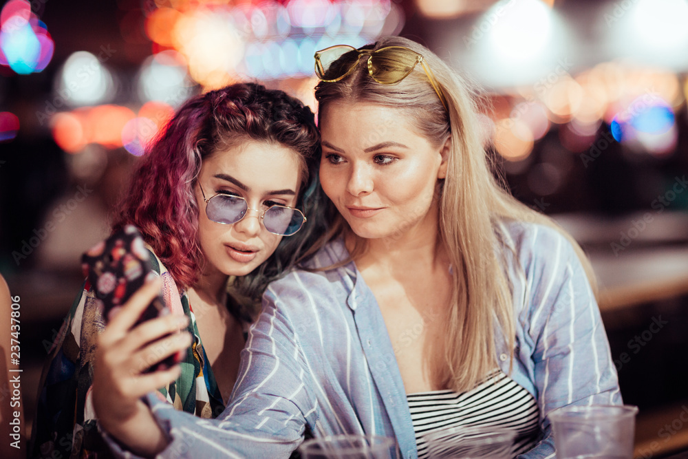 Female friends taking selfie at music festival