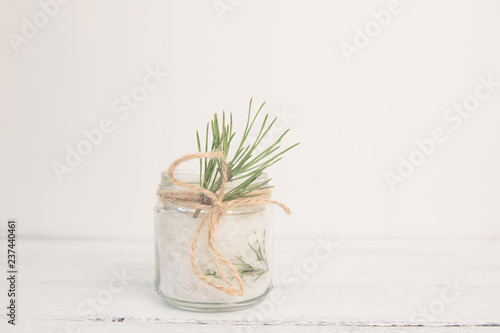 Natural herbal sea salt with aromatic fir - perfect for relaxation. Cosmetic jars and bottles with salt, lavender flowers