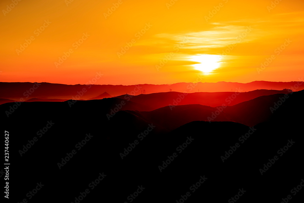 Black and Orange Sunset over Mountains