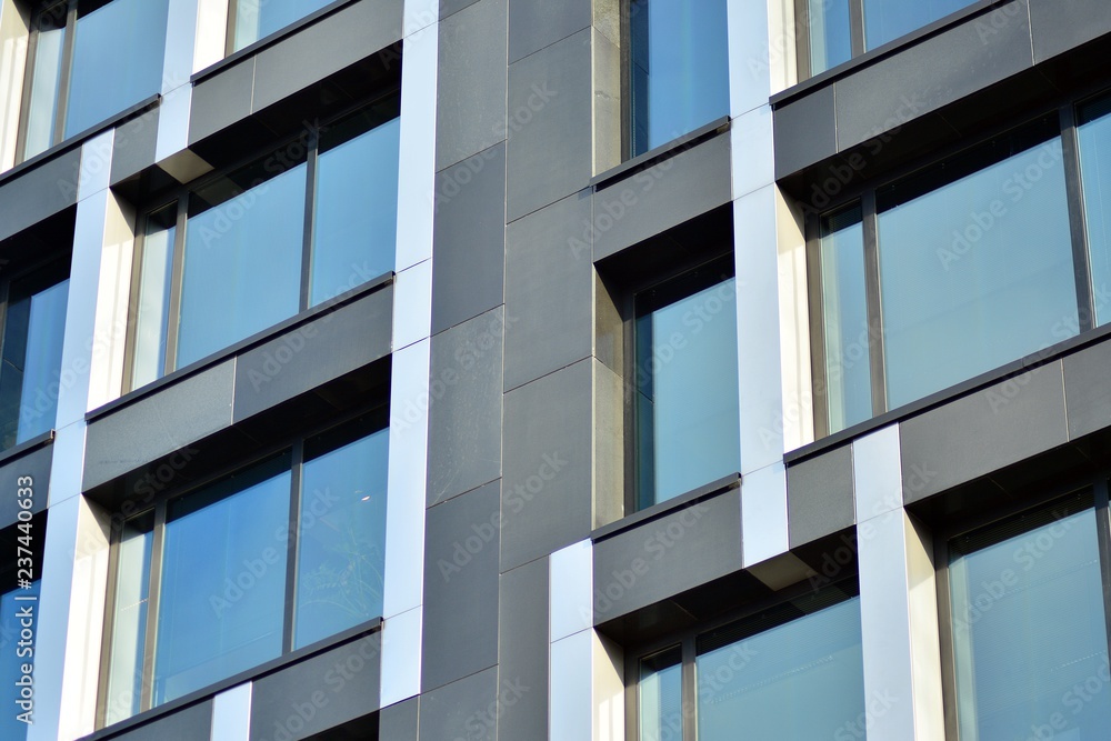 Modern apartment buildings on a sunny day with a blue sky. Facade of a modern apartment building Modern apartment buildings on a sunny day with a blue sky. Facade of a modern apartment building
