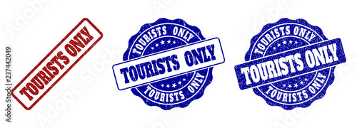 TOURISTS ONLY scratched stamp seals in red and blue colors. Vector TOURISTS ONLY labels with grainy texture. Graphic elements are rounded rectangles, rosettes, circles and text captions.