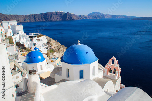 Santorini Island  Greece - November 17  2016  blue domes and white walls of the church on the famous romantic island of Santorini on the background of the Aegean Sea on a clear sunny day