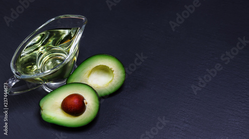 Close-up of an avocado and avocado oil shale board. Healthy food concept. copy space, top view