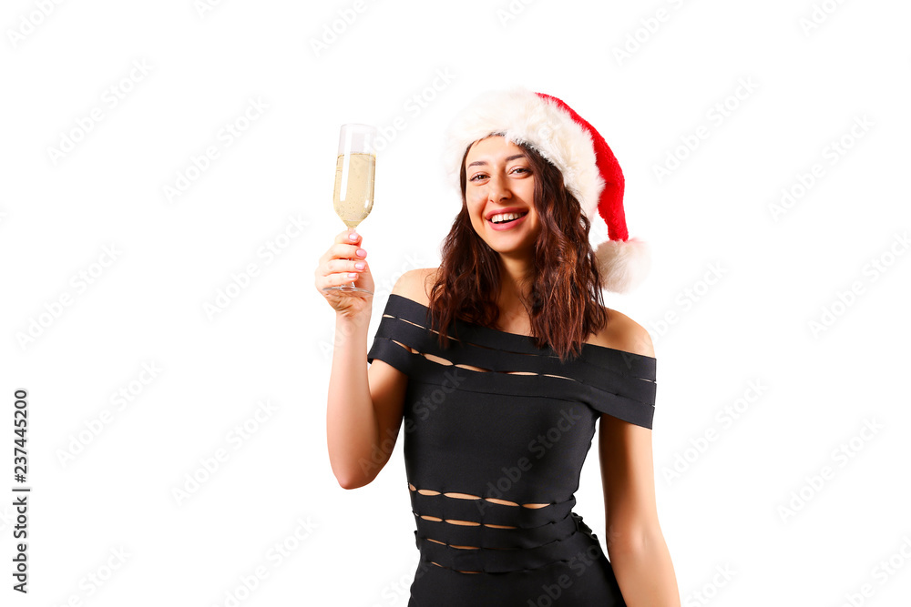 Portrait of young attractive woman wearing black tight sexy dress Santa Claus hat Drinking champagne and celebrating Christmas. Festive background, copy space, close up. Christmas mood concept.