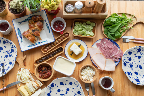 Traditional Turkish Breakfast, eggs with sucuk, bal kaymak, olives, ham, cheese. Rich brunch.