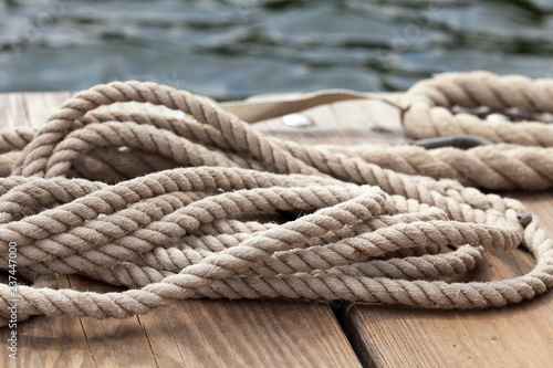 nautical rope close up on a wooden dock at waters edge