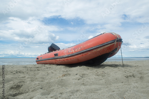 red rigid hulled boat on a alaskan beach  photo