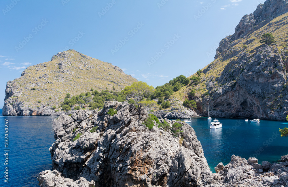 Puerto de Sa Calobra, Mallorca, Spain - July 20, 2013: View of yachts, rocks and bay