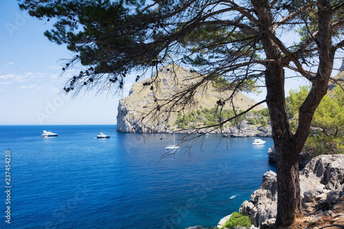 Puerto de Sa Calobra, Mallorca, Spain - July 20, 2013: View of yachts, rocks and bay