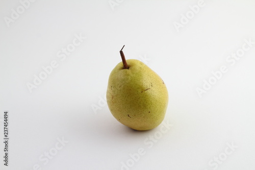 Ripe pear isolated on a white background. Pear with copy space for text. Green pear close-up. Pear on white background.
