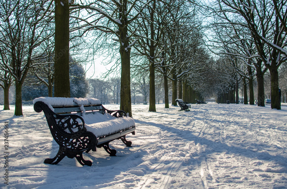 A park bench on a snowy day at Greenwich, London