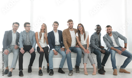 young people are waiting for an interview, sitting in the office lobby