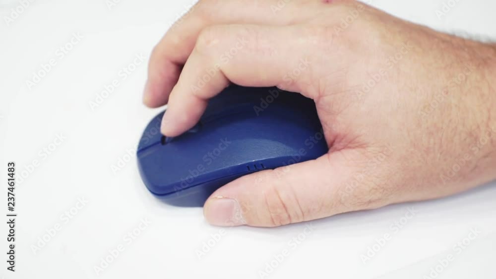 computer mouse in hand on a light surface.closeup computer mouse in hand on a light surface.closeup