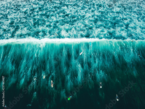 Fotografie Surfers on waves in Indian ocean, aerial view from above, Sri Lanka