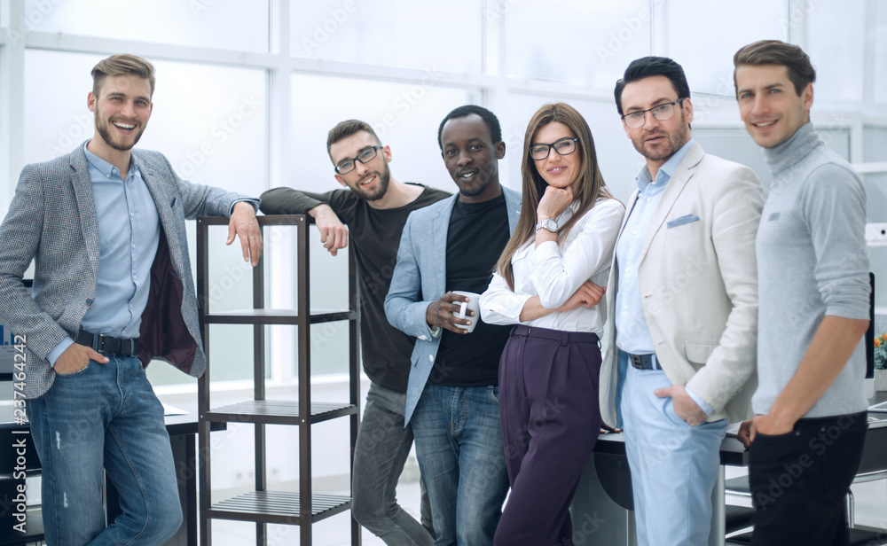 group of young professionals standing in the office group of young professionals standing in the office