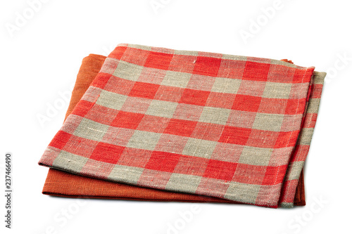 Red and red-checkered textile napkins stacked on white background