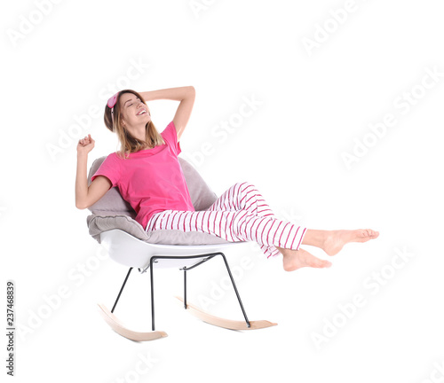 Young woman relaxing in armchair on white background