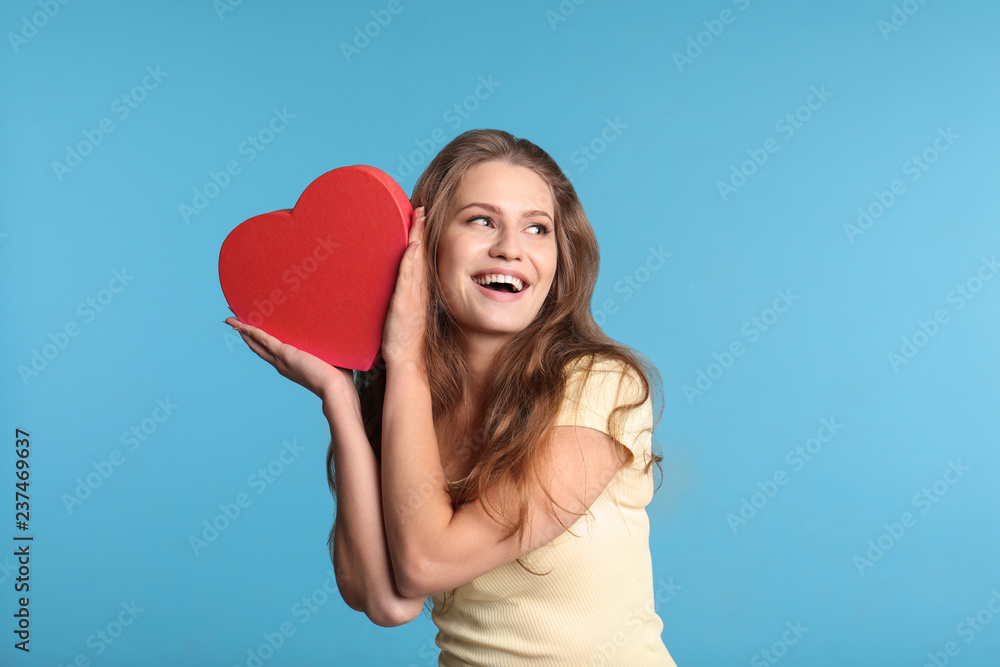 Portrait of young woman with decorative heart on color background Portrait of young woman with decorative heart on color background