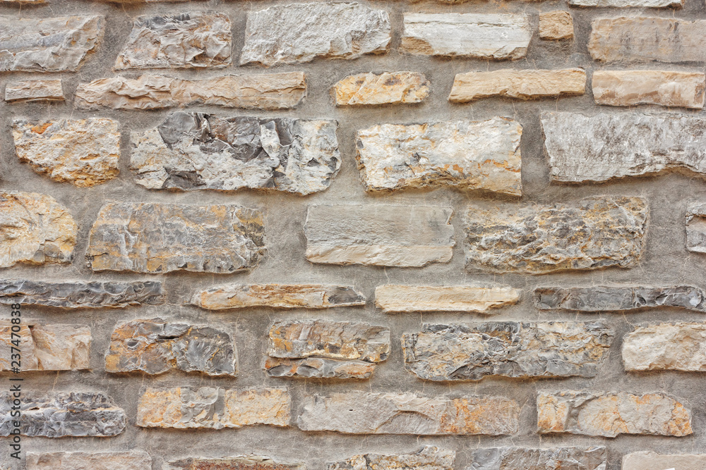 Fototapeta premium Old weathered brick wall of medieval fortress, horizontal grunge background