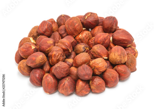 Handful of peeled ripe hazelnuts closeup, isolated on white background