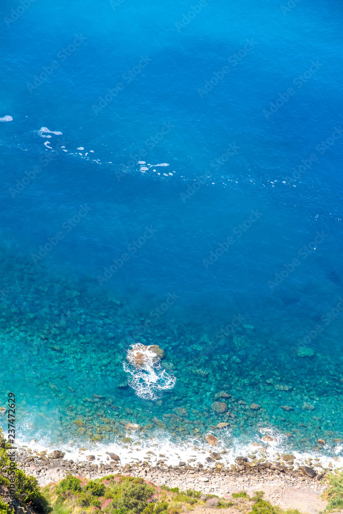 Rocks in the blue Mediterranean Sea on a bright sunny day. Rocks in the blue Mediterranean Sea on a bright sunny day.