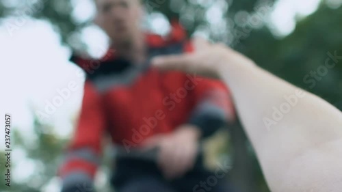 Pov of ill person lying on street and stretching hand to doctor, emergency, 911 photo