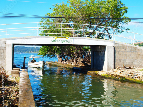 view of a bridge with a water taxy passing under