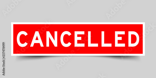 Square red color sticker with word cancelled on gray background