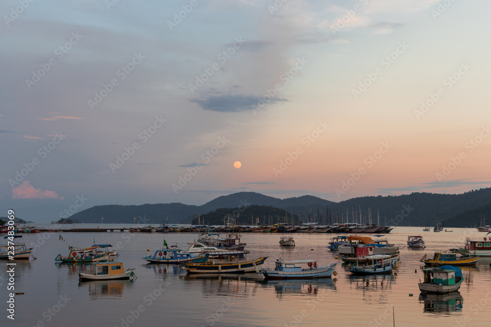 Sunset with the moon rising in Paraty, Rio de Janeiro Sunset with the moon rising in Paraty, Rio de Janeiro