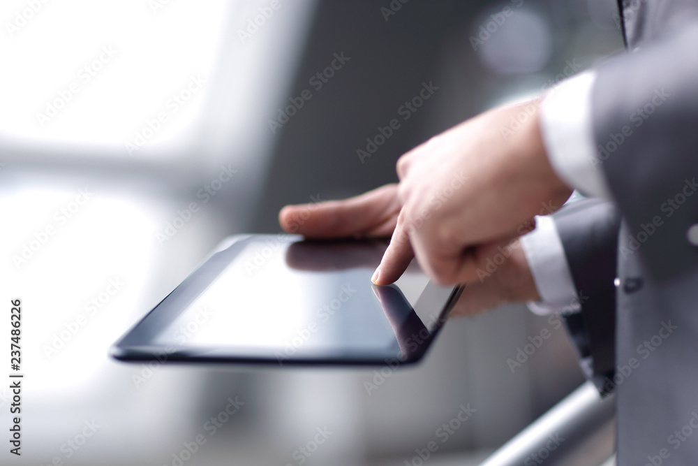close up.businessman pressing finger on digital tablet screen