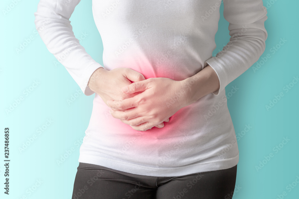 Woman stomachache on wall background. Woman stomachache on wall background.